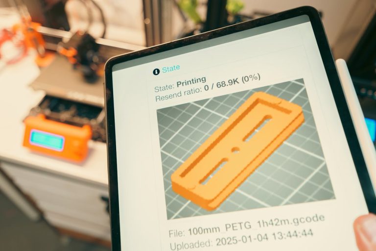 Crafting Captivating Headlines: Your awesome post title goes here Close-up of a digital tablet displaying a 3D printing process in a workshop setting.