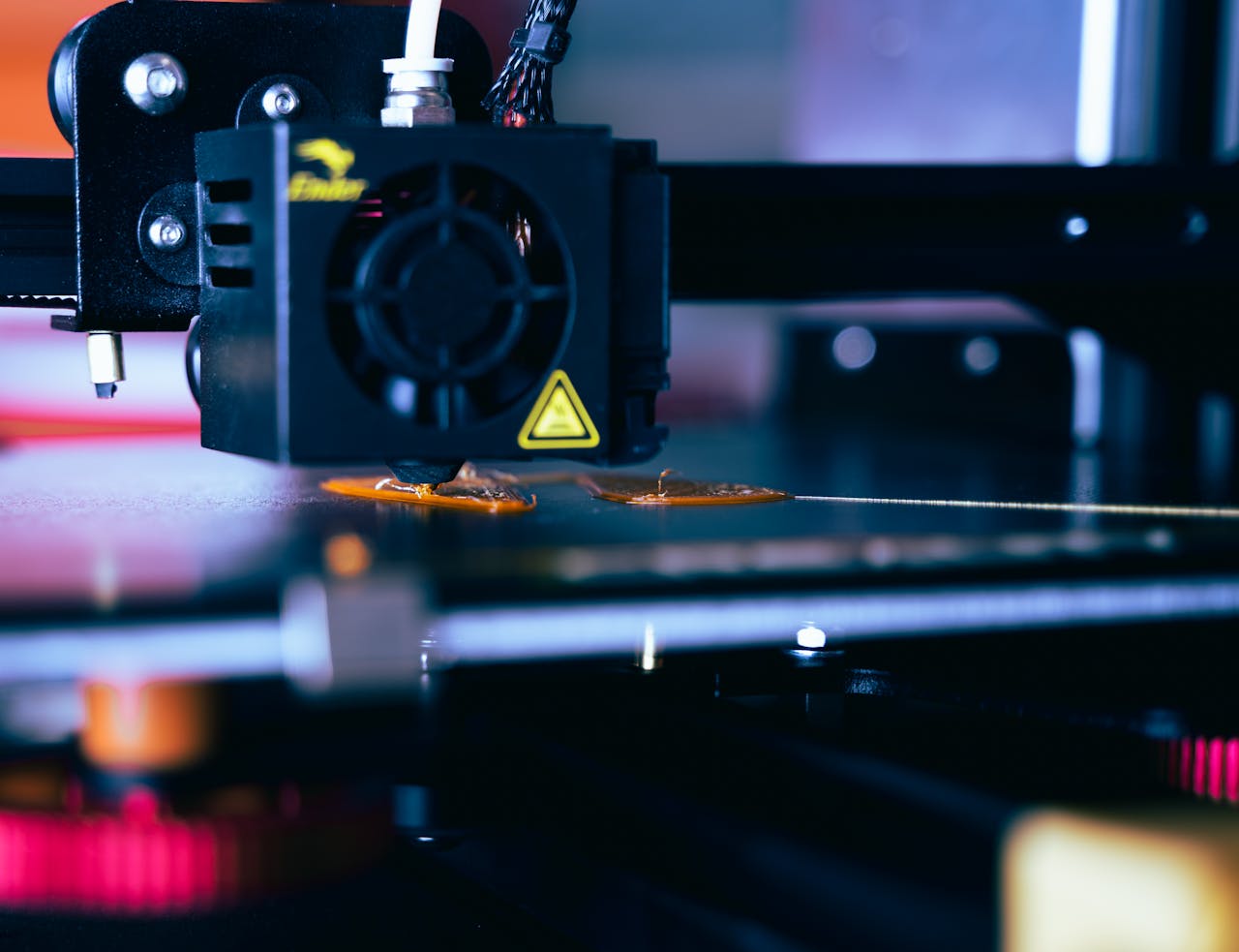 The Art of Drawing Readers In: Your attractive post title goes here Detailed view of a 3D printer head during operation, showcasing modern printing technology.